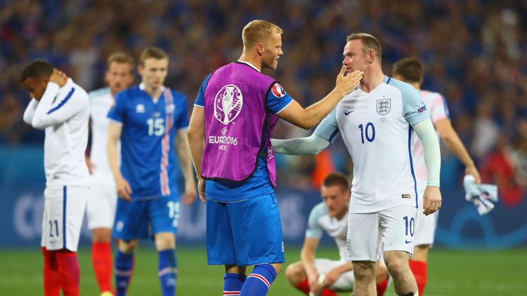 Wayne Rooney of England is consoled by Eidur Gudjohnsen of Iceland after the UEFA EURO 2016 round of 16 match in Nice