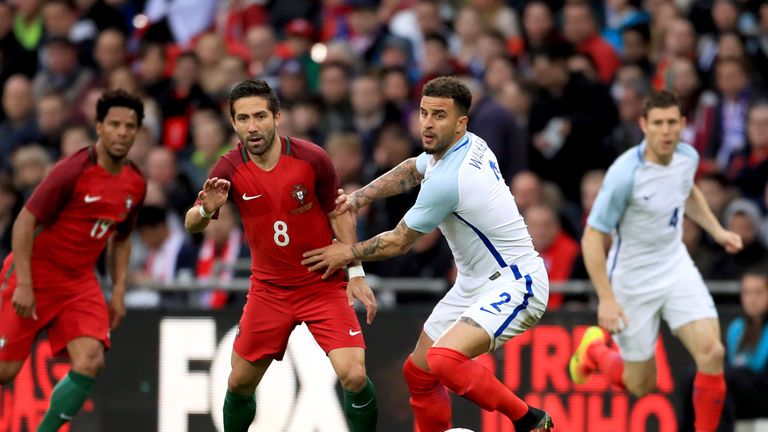 Portugal's Joao Moutinho (second left) and England's Kyle Walker (second right) battle for the ball