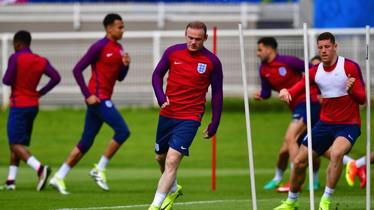 Wayne Rooney (C) performs a drill with team-mates during an England training session