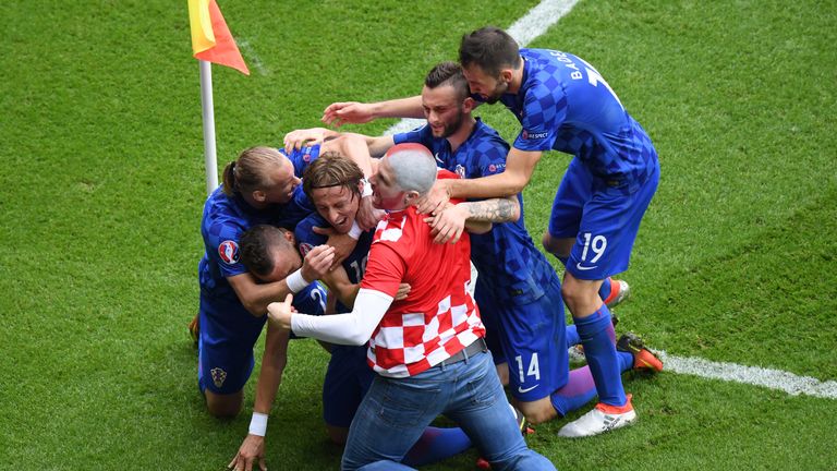 Luka Modric (3rd L) of Croatia celebrates scoring his team's first goal with his team-mates and a fan