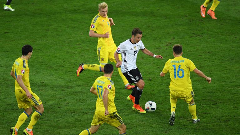 Mario Goetze of Germany controls the ball under pressure of Ukraine defense during the UEFA EURO 2016 Group C match