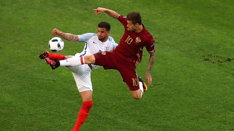 Kyle Walker of England and Fedor Smolov of Russia compete for the ball