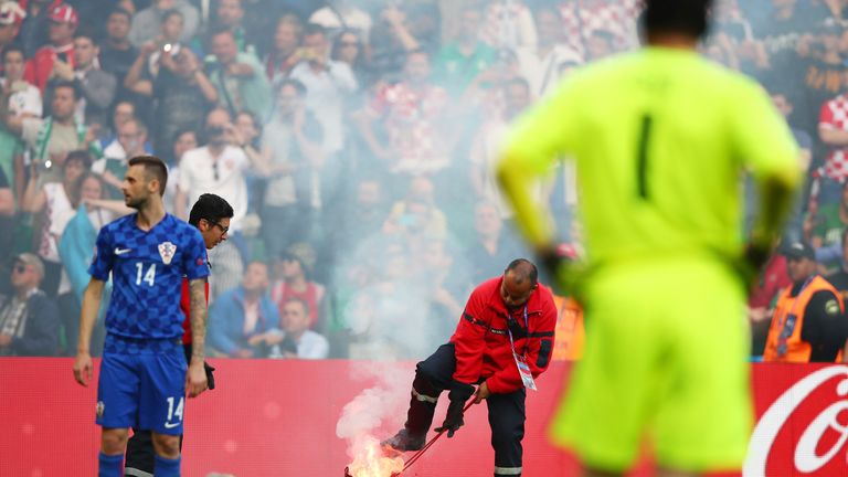 A fire marshal reacts after fireworks are thrown onto the pitch during the UEFA EURO 2016 Group D match between Czech Republic and Croatia