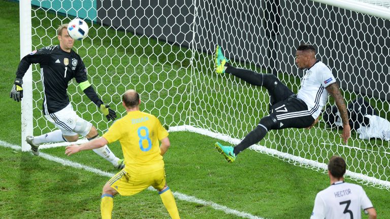 Germany's defender Jerome Boateng (2ndR) kicks the ball from his goal line during the Euro 2016 against Ukraine