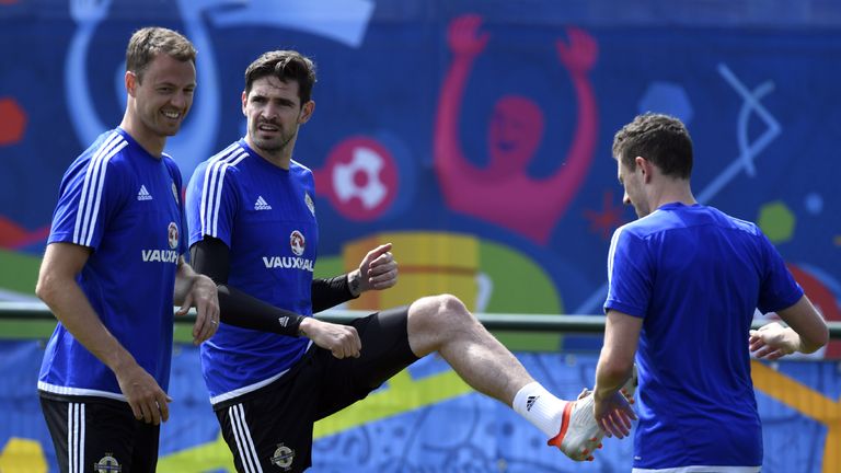 Northern Ireland's forward Kyle Lafferty (C) and defender Jonny Evans (L) attend a training session at the team's training ground in Saint George de Renein