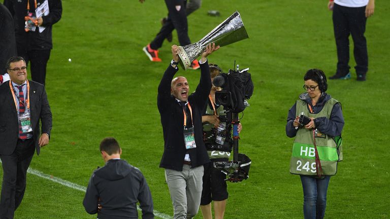 Ramon Rodriguez Verdejo, director of football of Sevilla lifts the Europa League trophy