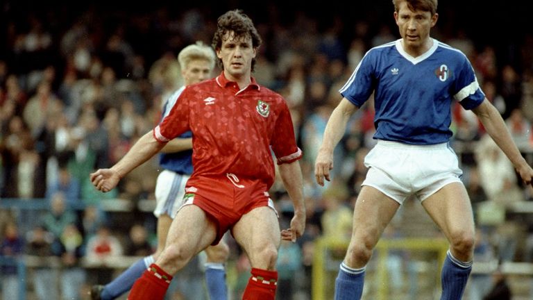 Mark Hughes of Wales takes on Atli Edvaldsson of Iceland during a fiendly match in Cardiff