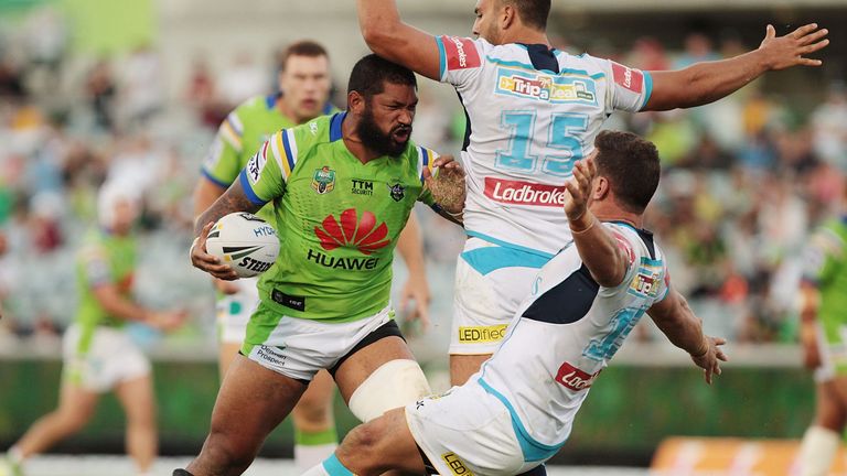 CANBERRA, AUSTRALIA - MARCH 26:  Frank Paul Nuuausala of the Raiders pushes Ryan James and Greg Bird of the Titans during the round four NRL match between 