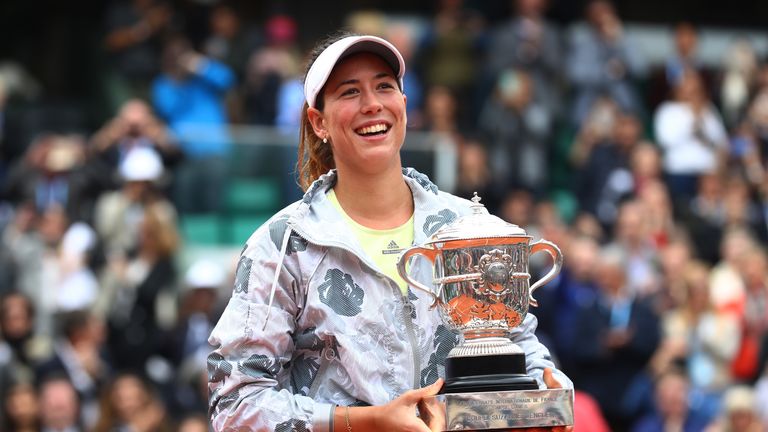 Garbine Muguruza poses with the trophy following her victory during the Ladies Singles final match against Serena Williams