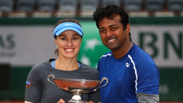 Martina Hingis and Leander Paes lift the trophy following victory during the Mixed Doubles final