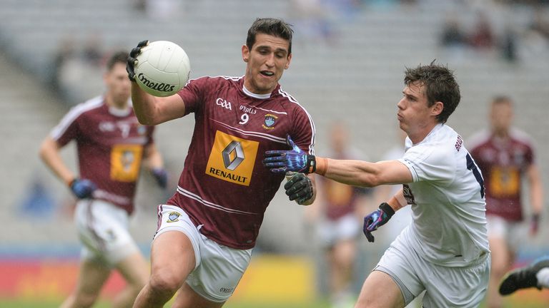 Denis Correen is tackled by Emmett Bolton of Kildare