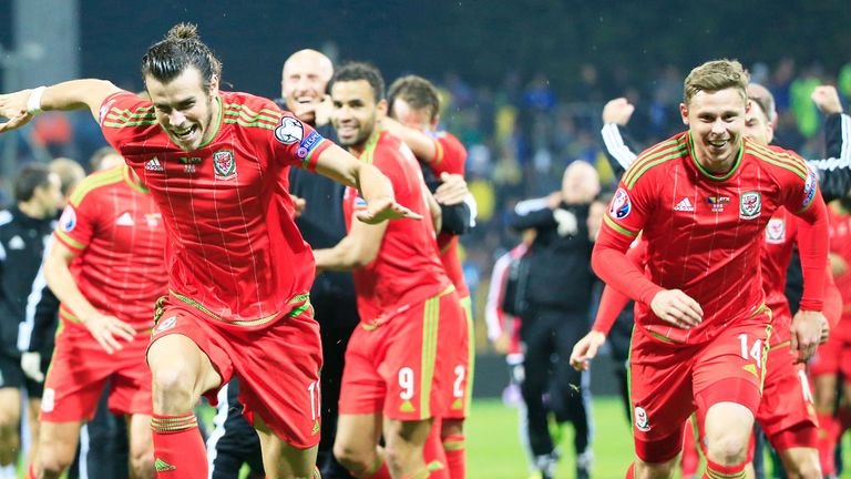 Gareth Bale (L) and Simon Church lead the celebrations as Wales qualify for Euro 2016