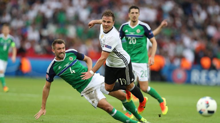 Gareth McAuley of Northern Ireland vies with Mario Gotze of Germany during the UEFA EURO 2016 Group C