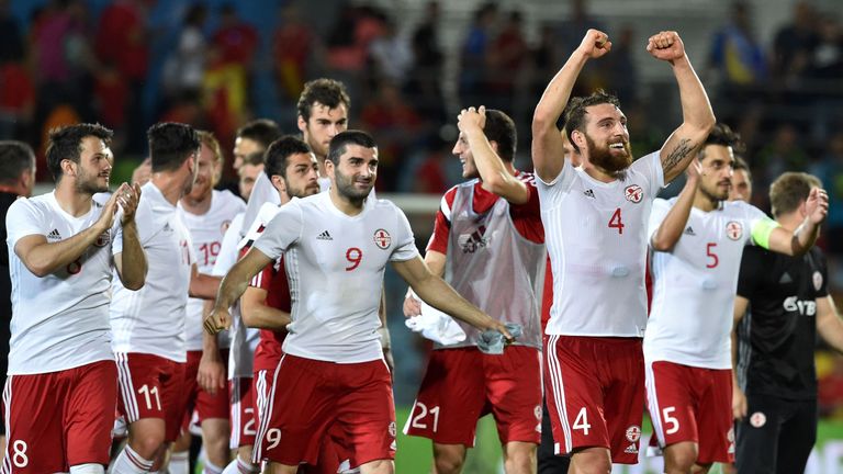 Georgia players celebrate their 1-0 victory at the end of the EURO 2016 friendly football match Spain vs Georgia at the Coliseum Alfonso Perez stadium in G