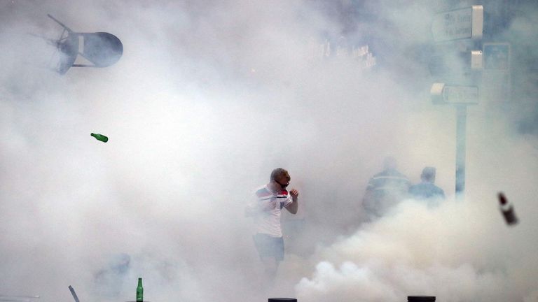 An England fan is surrounded by tear gas during a clash in Marseille