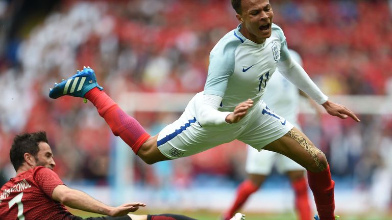 Turkey's defender Gokhan Gonul (L) vies with England's midfielder Dele Alli