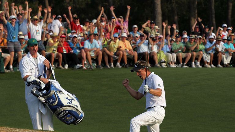 AUGUSTA, GA - APRIL 10:  Luke Donald of England celebrates after holing a pitch shot for birdie on the 18th hole as his caddie John McLaren look on during 