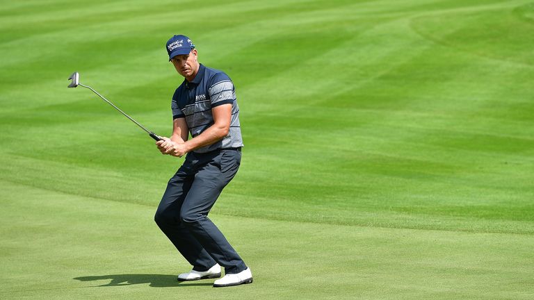 Henrik Stenson of Sweden reacts during the rain delayed third round of the BMW International Open at Gut Larchenhof