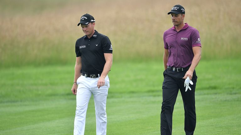 Henrik Stenson of Sweden walks with Danny Willett of England (L) during the second round of the BMW International Open