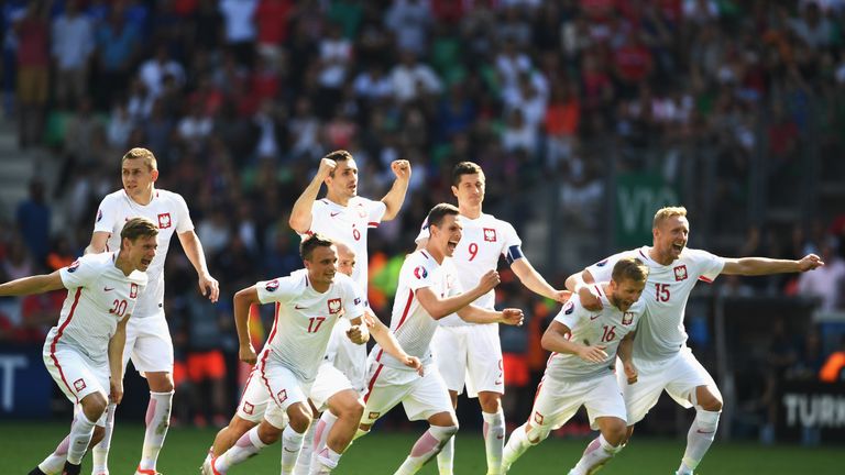 Poland players run to celebrate as Grzegorz Krychowiak scores the match-winning penalty against Switzerland