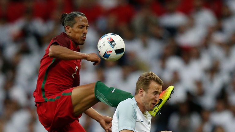 Portugal's defender Bruno Alves (L) fouls England's striker Harry Kane