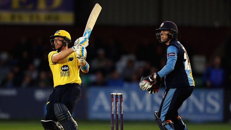 DERBY, ENGLAND - JUNE 17:  Ian Bell of Warwickshire hits the ball towards the boundary, as Tom Poynton of Derbyshire looks on during the NatWest T20 Blast 