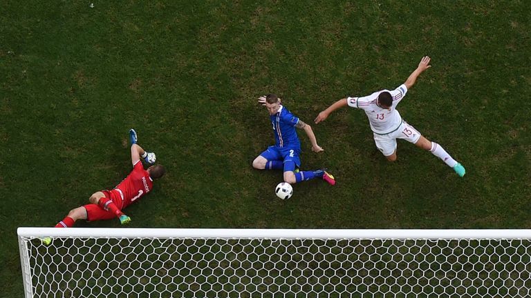 Iceland's defender Birkir Saevarsson (C) scores an own goal