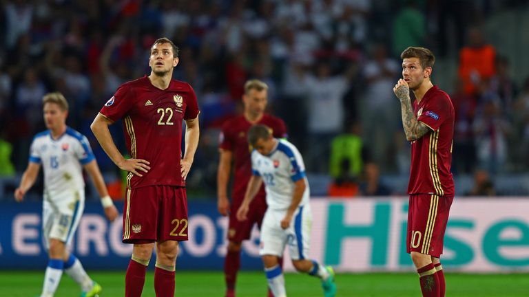 Igor Akinfeev of Russia and Artem Dzyuba look on 