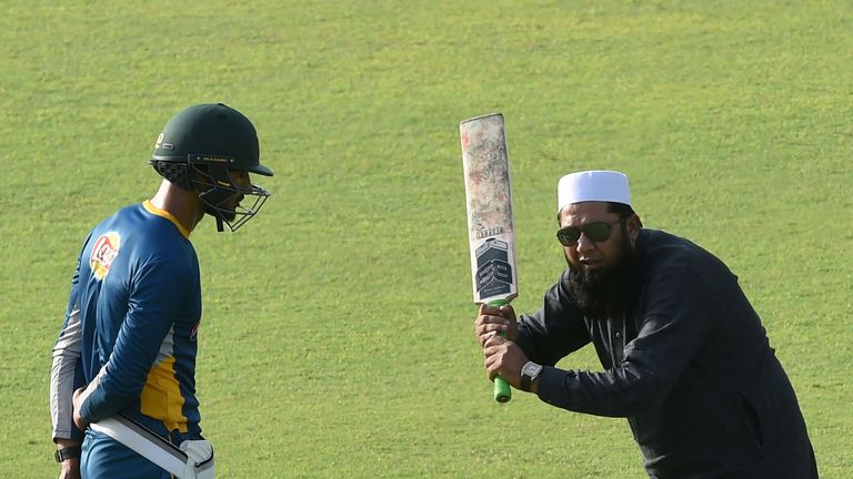 Pakistani chief selector Inzamam-ul-Haq (R) gives batting tips to team cricket player Shan Masood during a training camp at the Gaddafi Cricket Stadium in 