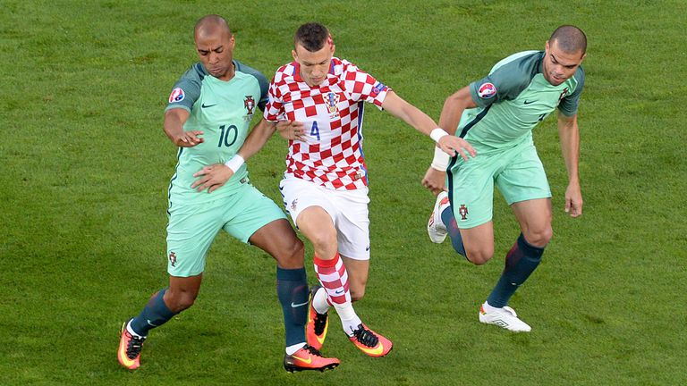 Croatia's midfielder Ivan Perisic (C) vies with Portugal's midfielder Joao Mario (L) and defender Pepe 