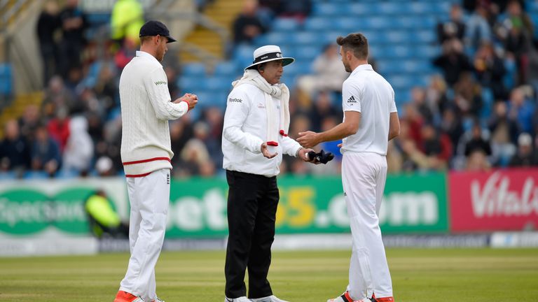 England bowler James Anderson is warned by umpire Sundaram Ravi for running on the pitch