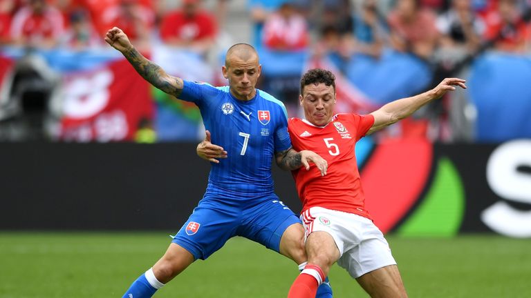 BORDEAUX, FRANCE - JUNE 11: Vladimir Weiss of Slovakia and James Chester of Wales compete for the ball during the UEFA EURO 2016 Group B match between Wale