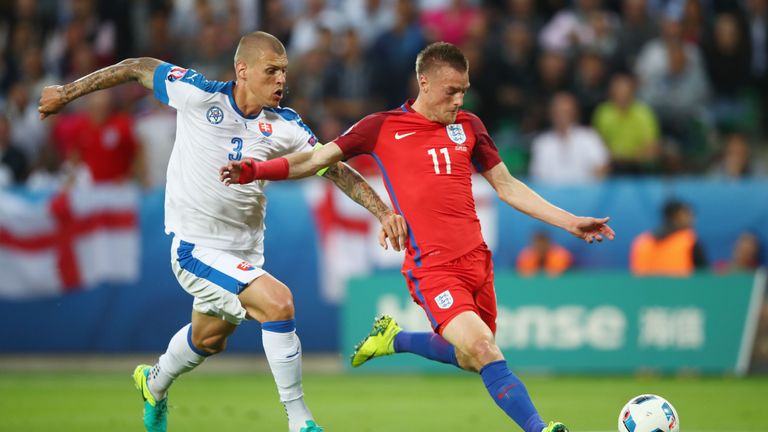 Jamie Vardy of England and Martin Skrtel of Slovakia compete for the ball