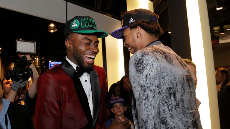 Ingram shares a joke with Jaylen Brown (left), who was selected third by the Boston Celtics