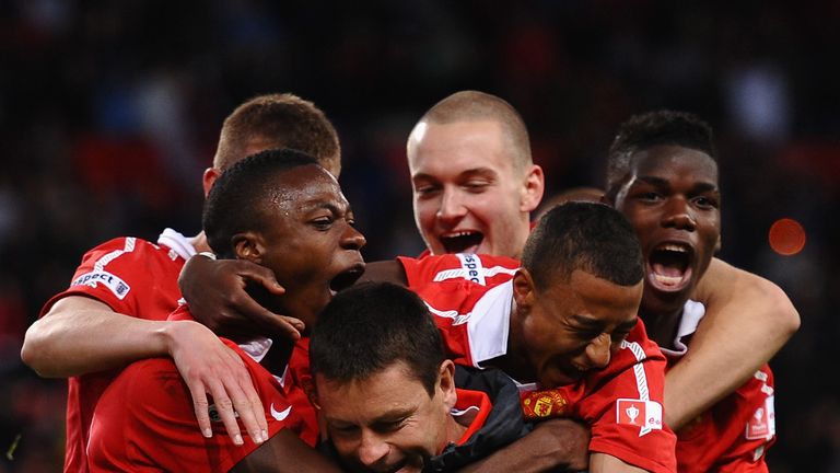 Paul McGuinness is mobbed by the likes of Jesse Lingard and Paul Pogba following Manchester United's FA Youth Cup Final win over Sheffield United in 2011