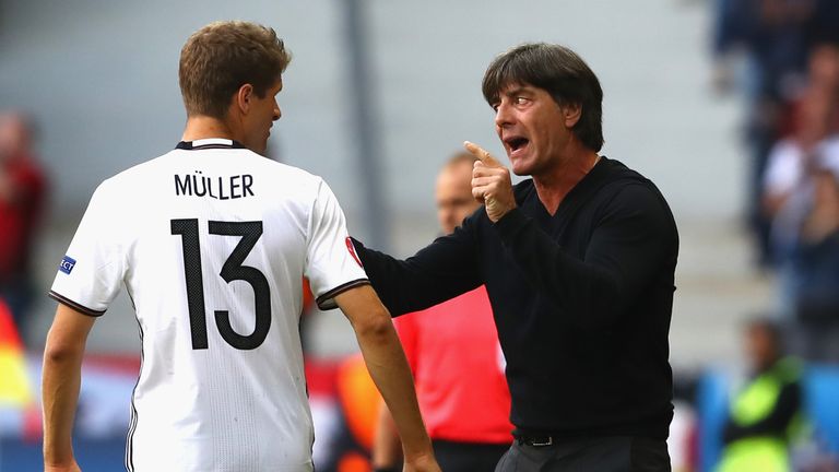Joachim Low, head coach of Germany instructs Thomas Mueller (L)