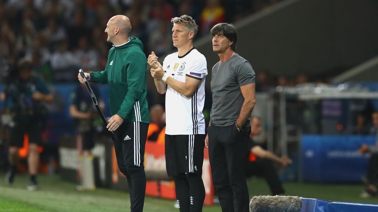 Joachim Low (R) Germany coach, talks to Bastian Schweinsteiger (C)