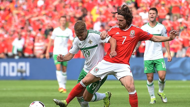 Wales' midfielder Joe Allen (R) vies for the ball with Northern Ireland's midfielder Jamie Ward during the Euro 2016 match