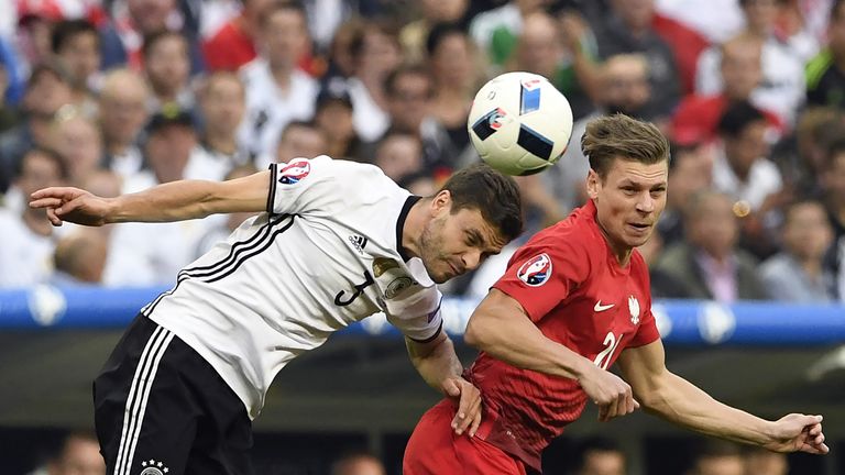Germany defender Jonas Hector (L) vies for a header with Poland's Lukasz Piszczek