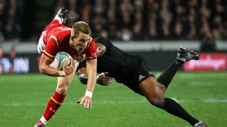 Liam Williams of Wales (L) is tackled by Julian Savea