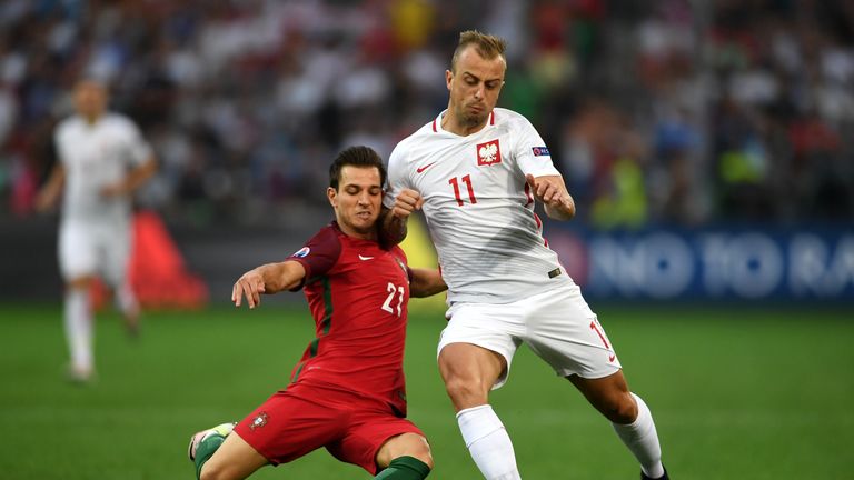 Kamil Grosicki is tackled by Cedric Soares 