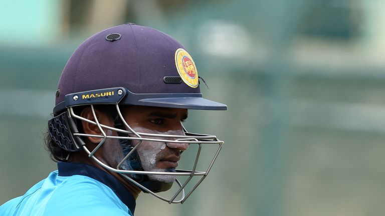 Sri Lankan cricketer Kusal Perera walks with his equipment during a practice session at the R. Premadasa Stadium in Colombo on May 13, 2016. 
Sri Lanka's w