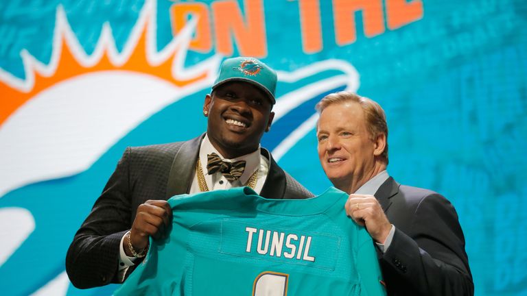 CHICAGO, IL - APRIL 28:  (L-R) Laremy Tunsil of Ole Miss holds up a jersey with NFL Commissioner Roger Goodell after being picked #13 overall by the Miami 