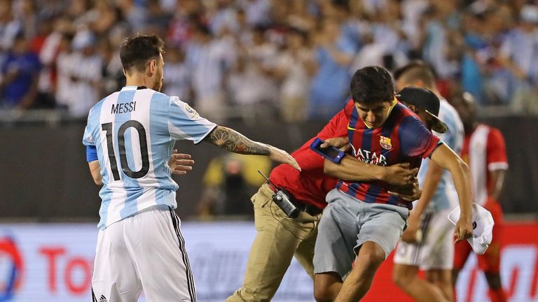 CHICAGO, IL - JUNE 10:  A fan is brought down by a security guard after reaching Lionel Messi #10 of Argentina after a match against Panama in the 2016 Cop