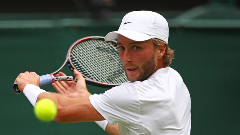 LONDON, ENGLAND - JUNE 28:  Liam Broady of Great Britain plays a backhand during the Men's Singles first round match against Andy Murray of Great Britain o