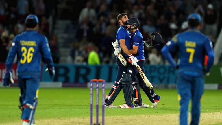 Lian Plunkett of England is congratulated by team mate Chris Woakes after hitting a a six off the last ball the tie the 1st ODI