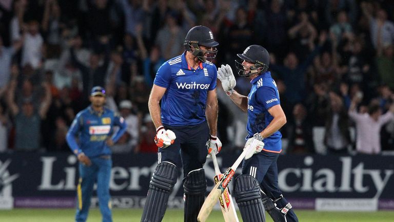 England's Liam Plunkett (L) celebrates with England's Chris Woakes