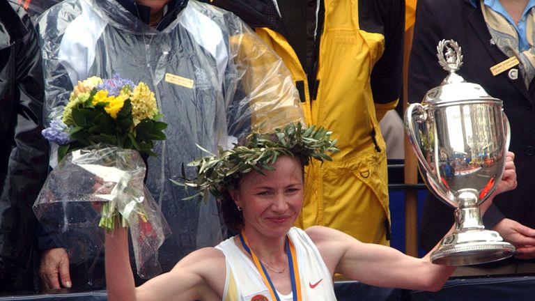 Lidiya Grigoryeva of Russia raises her trophy in victory after winning the Boston marathon