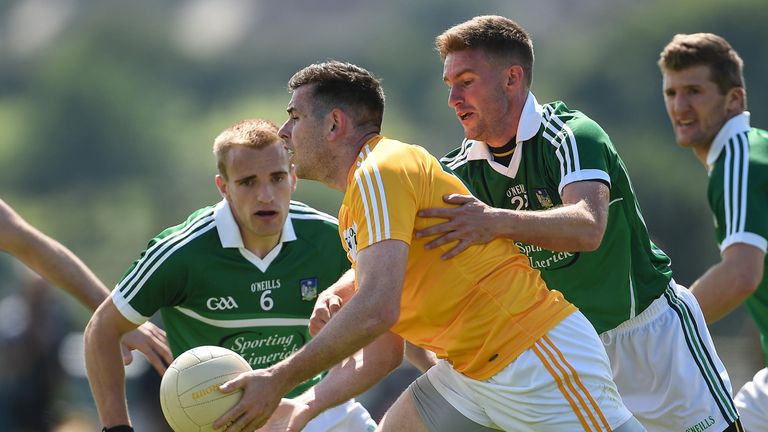 Sean Burke of Antrim is tackled by Paul Hannon of Limerick  at Corrigan Park in Belfast.