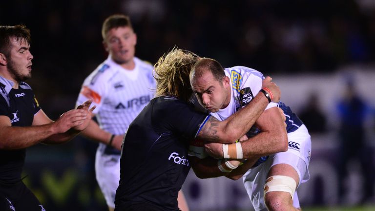 NEWCASTLE UPON TYNE, ENGLAND - NOVEMBER 7: Lou Reed of Cardiff Blues is tackled by George McGuigan and Scott MacLeod of Newcastle Falcons during the second